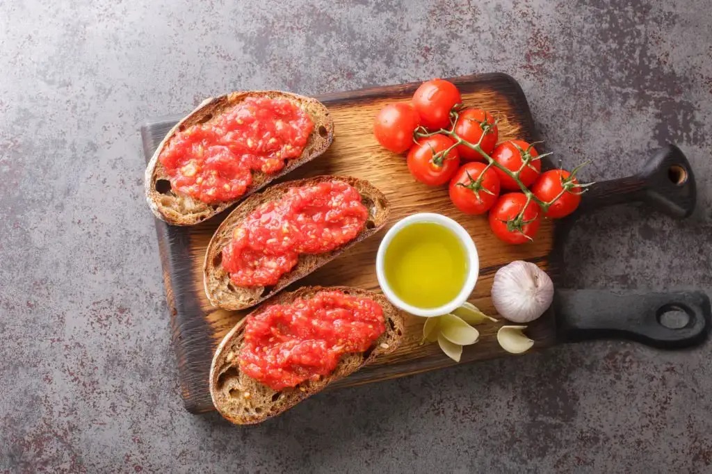Two little sisters drinking juice